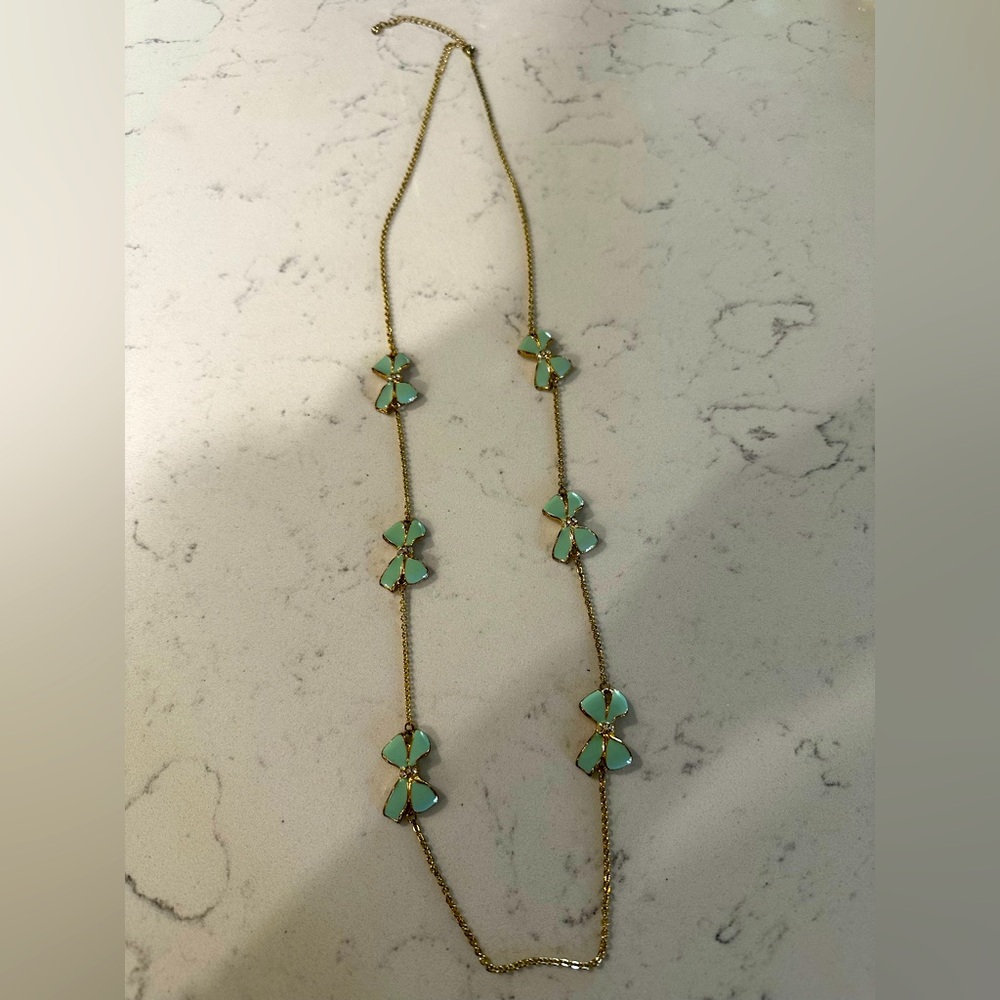 Long, gold necklace with Tiffany blue bows and tiny diamonds.
